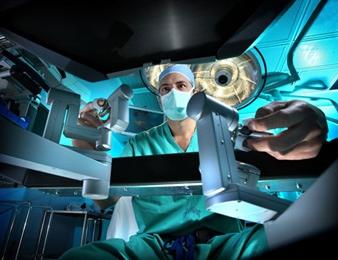 Dr. Pavlovich operating the robotic console in the operating room